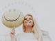 Woman Holding a Smiley Balloon