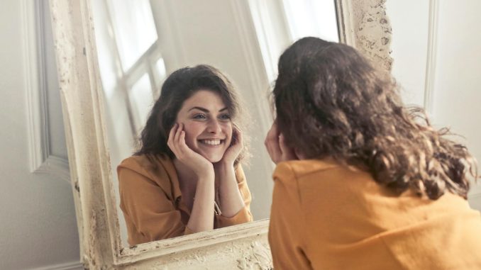 Photo of Woman Looking at the Mirror